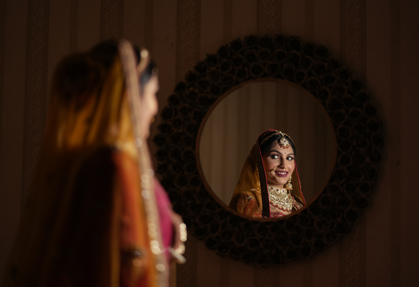 Bride creating a mirror effect in a reflective bridal portrait