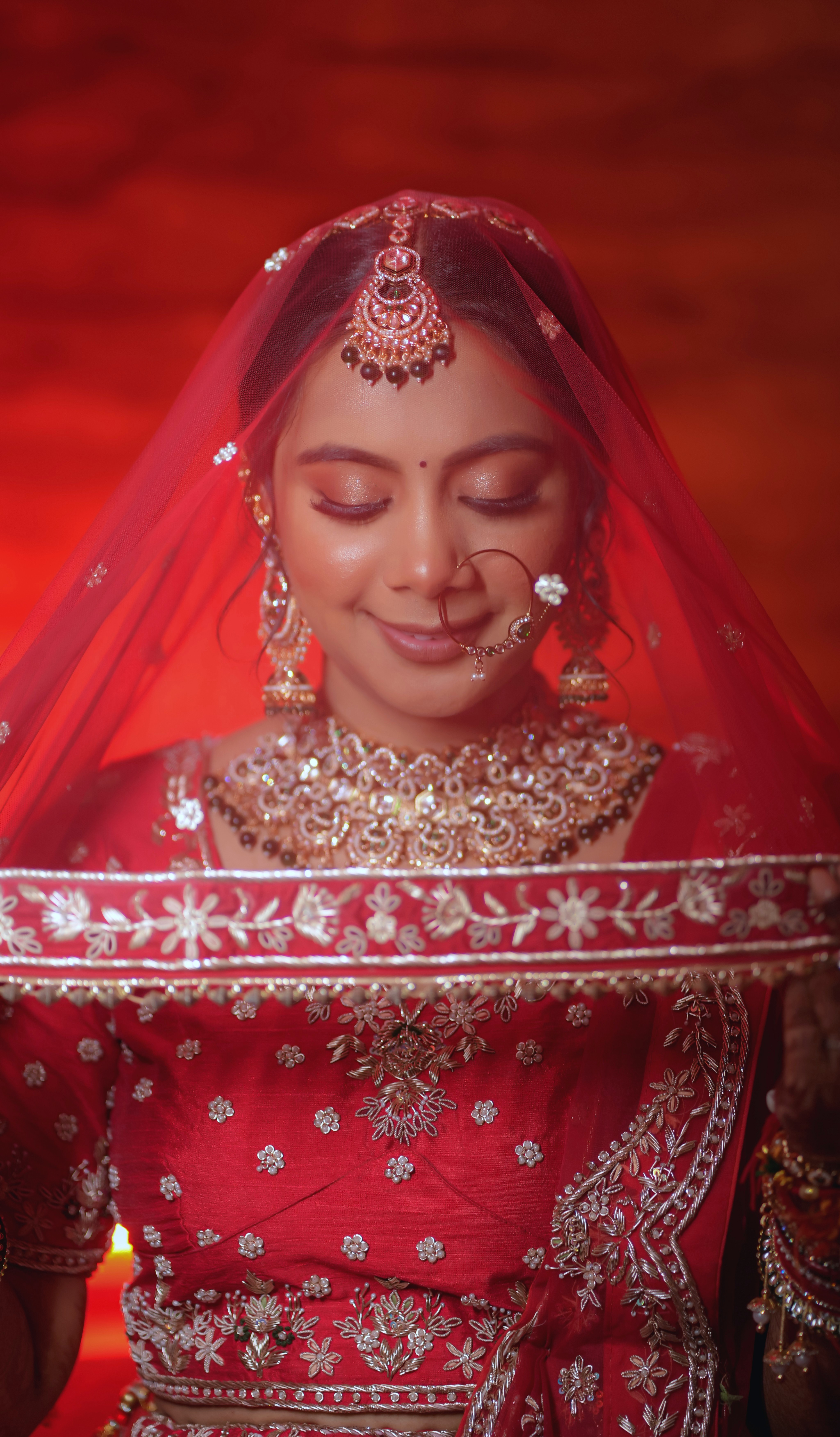 Bride posing softly beneath her veil